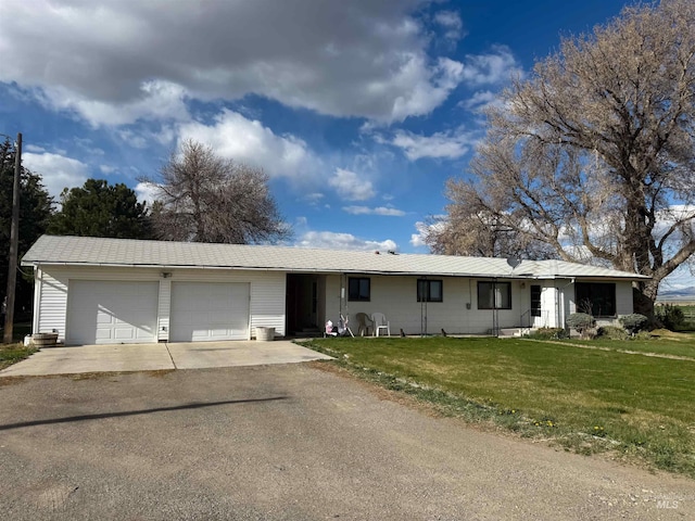 single story home with a garage, driveway, and a front lawn