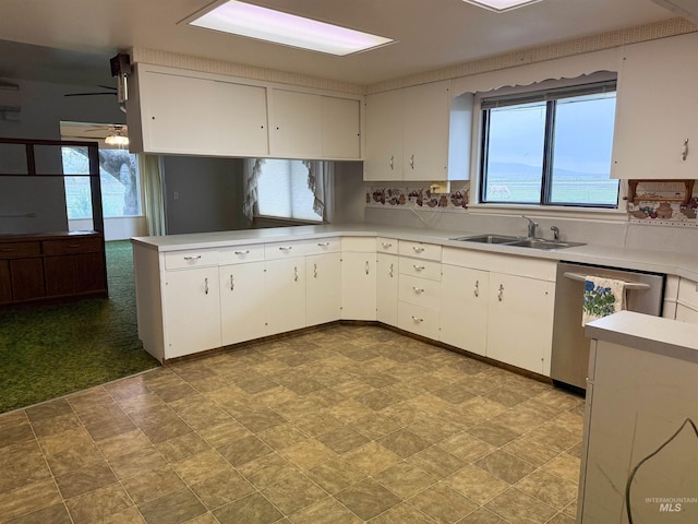 kitchen featuring light countertops, plenty of natural light, a sink, and dishwasher