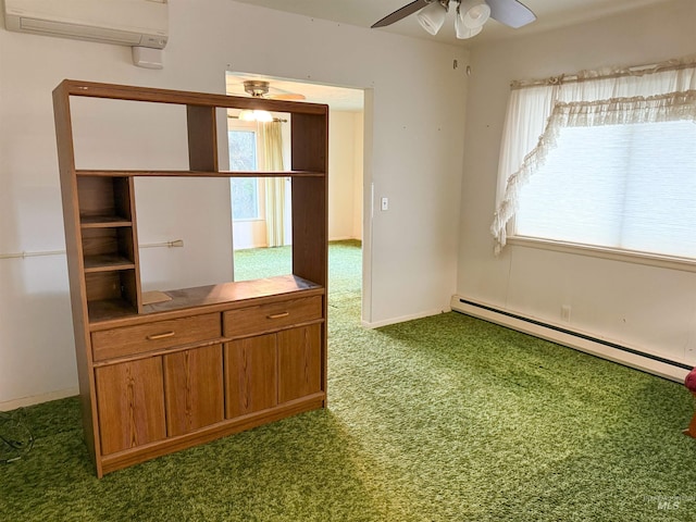 carpeted spare room featuring a baseboard radiator, an AC wall unit, ceiling fan, and a wealth of natural light