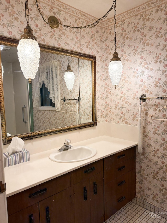 bathroom featuring vanity, tile patterned flooring, and wallpapered walls