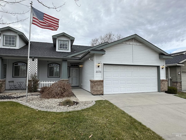 view of front of property with a front lawn, a porch, and a garage