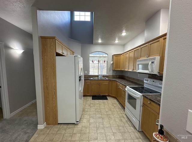 kitchen featuring sink and white appliances