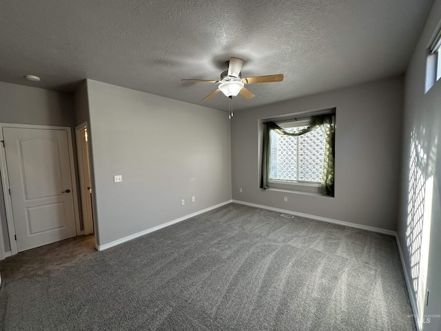 unfurnished room featuring carpet floors, a textured ceiling, and ceiling fan