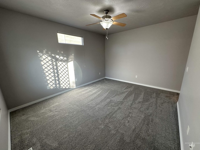 carpeted spare room featuring a textured ceiling and ceiling fan