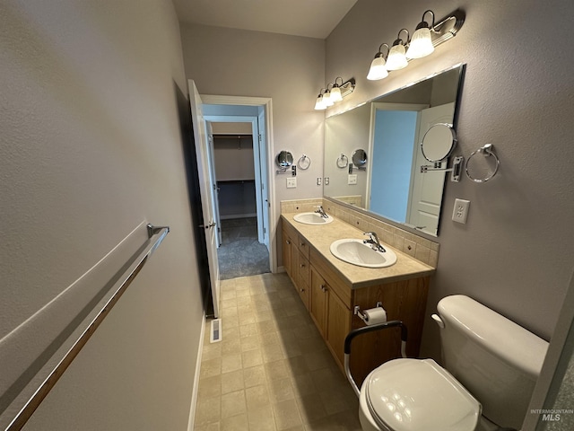 bathroom featuring toilet and vanity