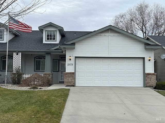 view of front of home with a front yard and a garage