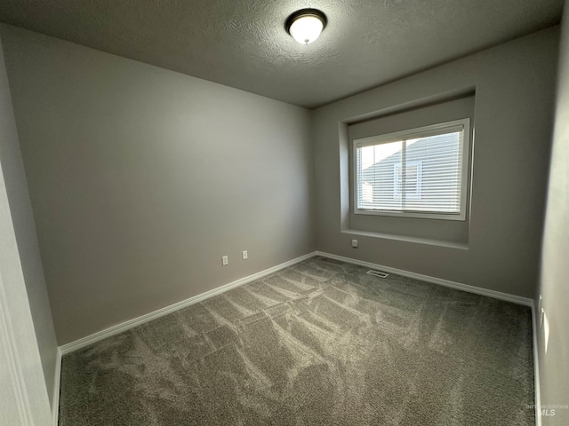 carpeted spare room featuring a textured ceiling