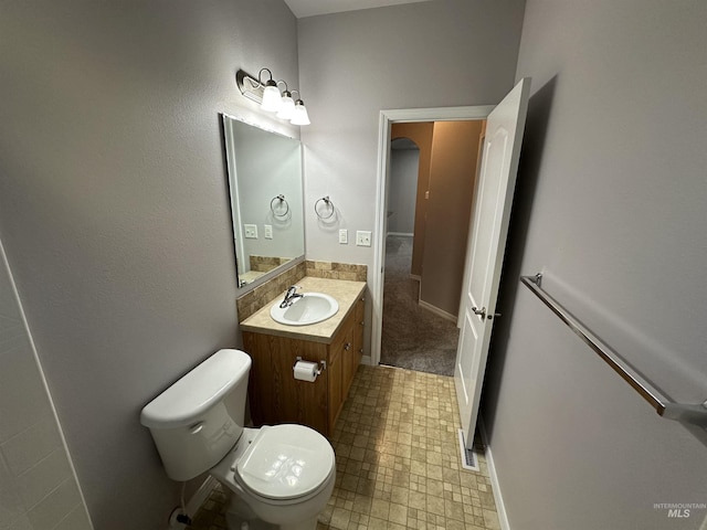 bathroom with toilet and vanity