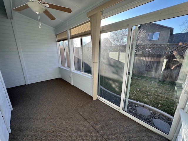 unfurnished sunroom with ceiling fan and lofted ceiling