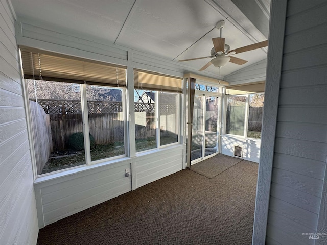 unfurnished sunroom with ceiling fan and vaulted ceiling