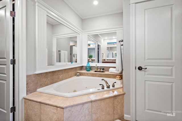 bathroom featuring a tub with jets and crown molding