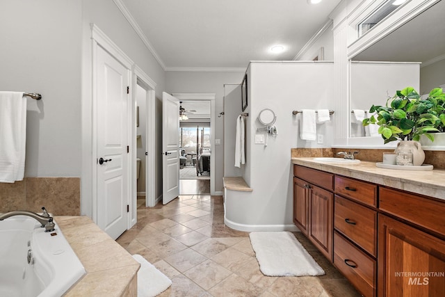 ensuite bathroom featuring ensuite bathroom, a tub to relax in, vanity, baseboards, and crown molding