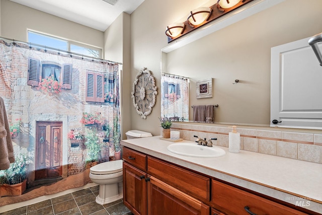 bathroom featuring toilet, tile patterned floors, and vanity