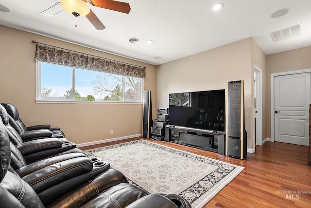 living area featuring wood finished floors, visible vents, and baseboards