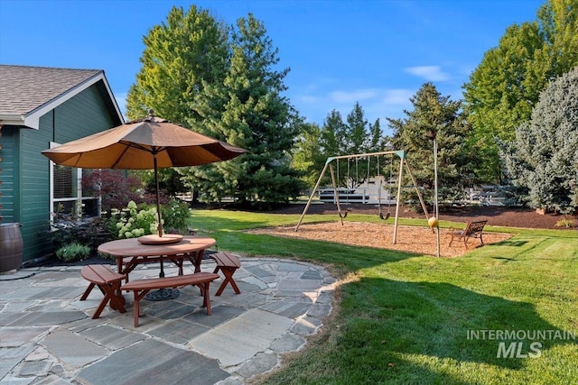 exterior space featuring a yard, outdoor dining area, and a patio