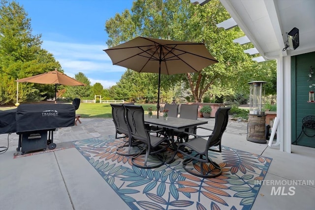 view of patio with outdoor dining space and a grill