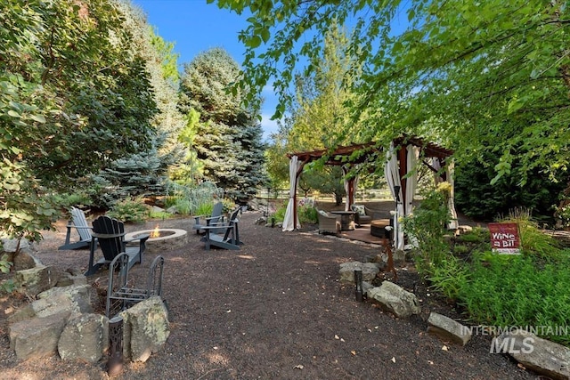 view of yard with a fire pit