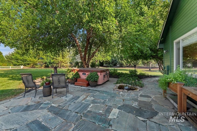 view of patio with fence and a hot tub