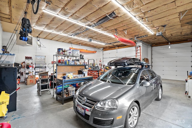 garage with a garage door opener and a workshop area