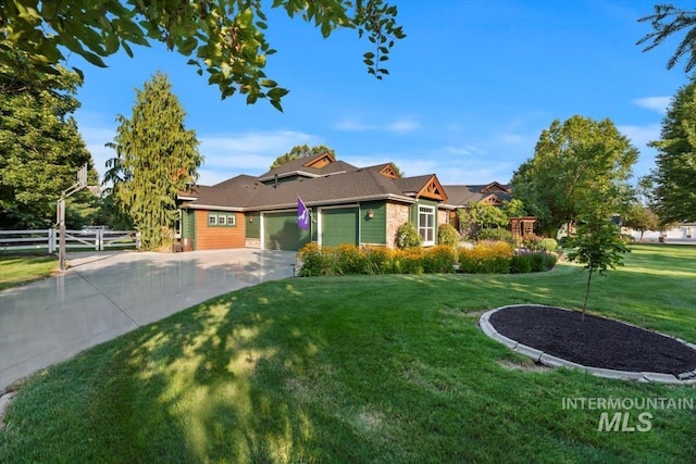 view of front of house featuring a garage, fence, a front lawn, and concrete driveway