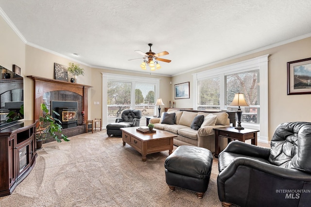 living room featuring a textured ceiling, carpet floors, a tiled fireplace, and crown molding