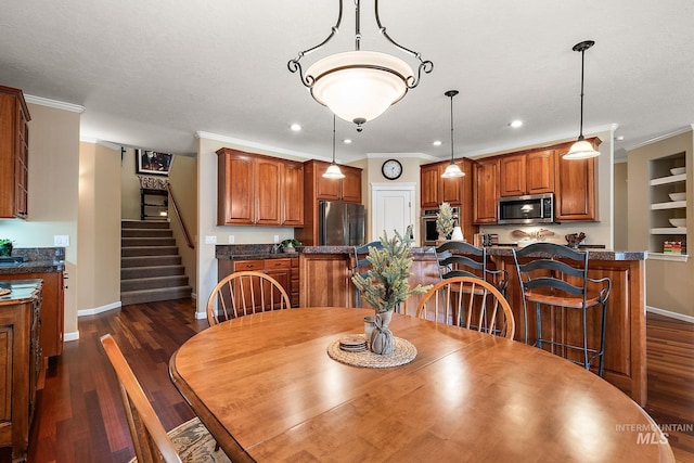 dining area with baseboards, ornamental molding, and dark wood finished floors