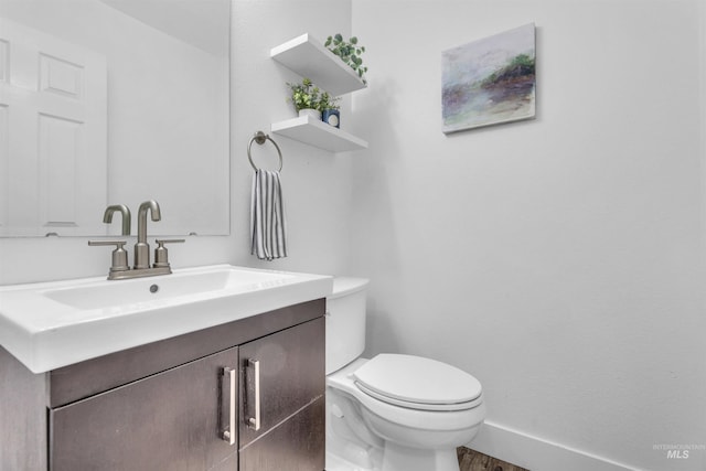 5467 N Claret Cup Way, Meridian, ID 83646 - half bathroom featuring vanity, toilet, baseboards, and wood finished floors