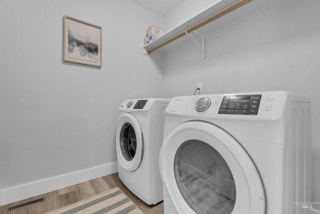 5467 N Claret Cup Way, Meridian, ID 83646 - laundry room with washer and dryer, light wood finished floors, and baseboards
