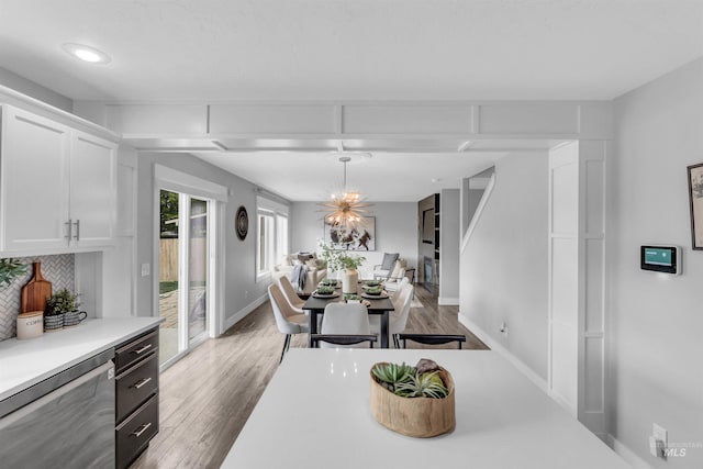 5467 N Claret Cup Way, Meridian, ID 83646 - dining space featuring wood finished floors, baseboards, a chandelier, and recessed lighting