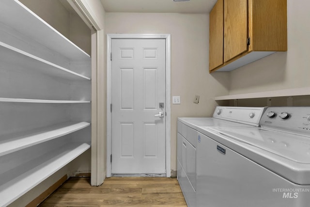 321 S Powerline Rd, Nampa, ID 83686 - washroom featuring cabinet space, separate washer and dryer, and light wood-style flooring