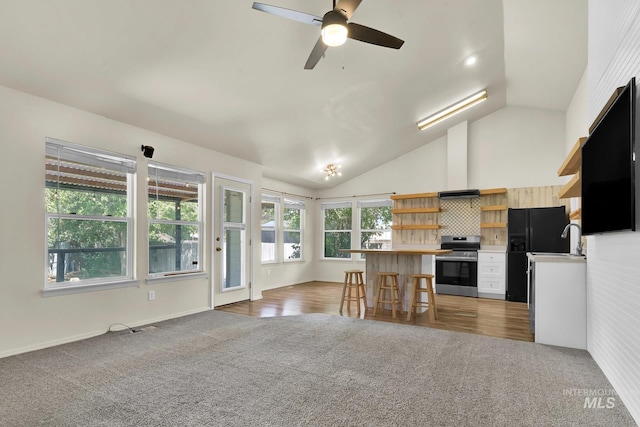 321 S Powerline Rd, Nampa, ID 83686 - kitchen with stainless steel stove, open shelves, light carpet, open floor plan, and light countertops
