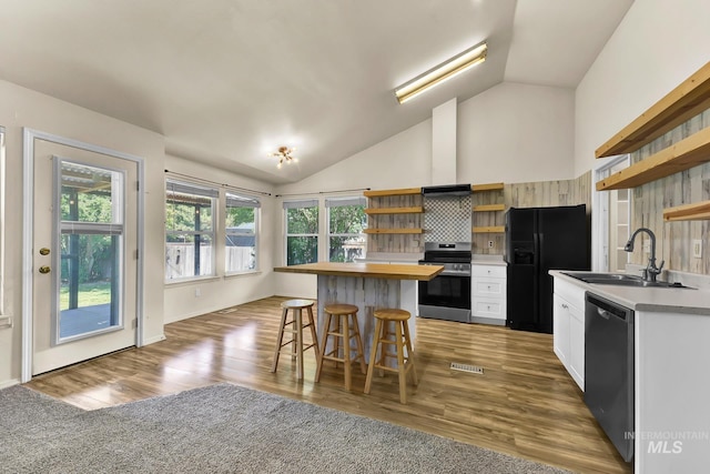 321 S Powerline Rd, Nampa, ID 83686 - kitchen featuring open shelves, stainless steel range with electric cooktop, black refrigerator with ice dispenser, dishwasher, and vaulted ceiling