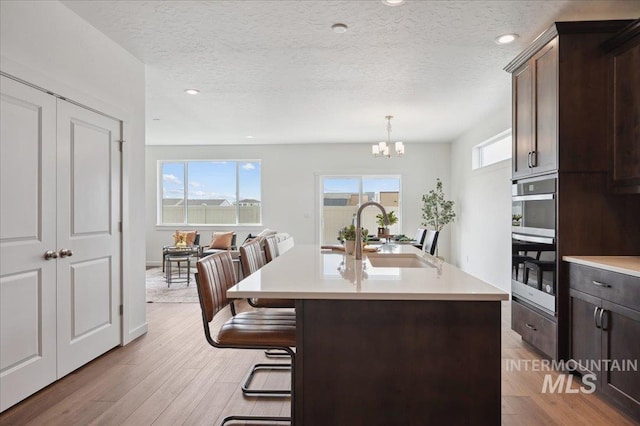 6303 W Pewter Point St, Meridian, ID 83646 - kitchen with a sink, a chandelier, light countertops, plenty of natural light, and a textured ceiling
