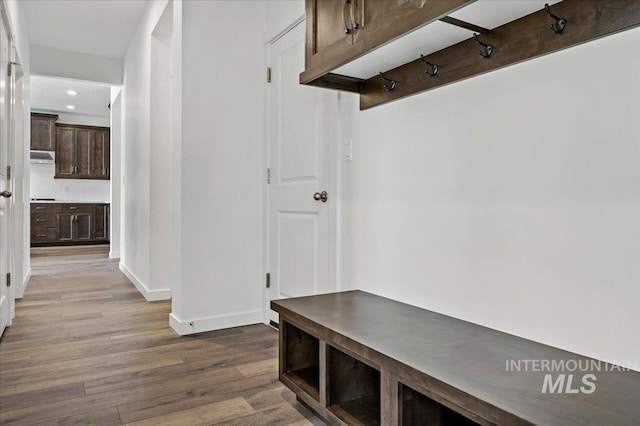 mudroom featuring recessed lighting, wood finished floors, and baseboards