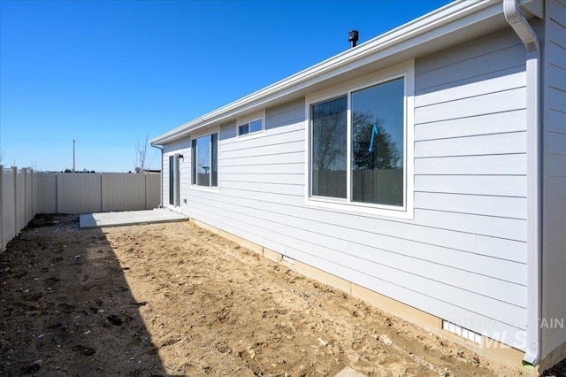 view of side of home with fence