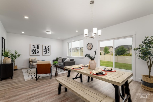 dining space with recessed lighting, a notable chandelier, light wood-style flooring, and baseboards