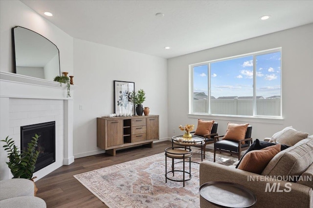 6303 W Pewter Point St, Meridian, ID 83646 - living room featuring dark wood-style flooring, recessed lighting, a brick fireplace, and baseboards