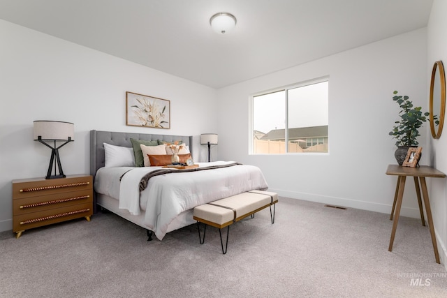 bedroom with carpet, visible vents, and baseboards