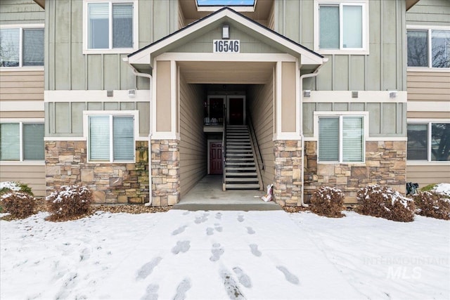 view of snow covered property entrance