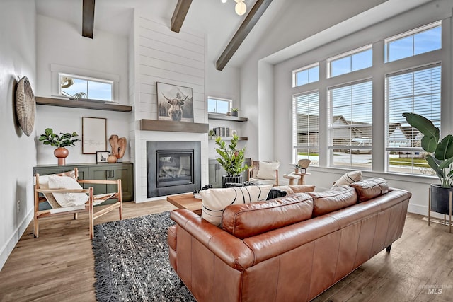 11844 N 21st Ave, Boise, ID 83714 - living room with beamed ceiling, baseboards, wood finished floors, a high ceiling, and a large fireplace