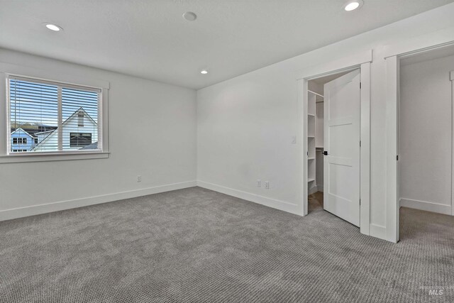 11844 N 21st Ave, Boise, ID 83714 - unfurnished bedroom with carpet floors, a spacious closet, recessed lighting, baseboards, and a closet