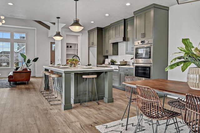 11844 N 21st Ave, Boise, ID 83714 - kitchen with stainless steel appliances, light wood-style flooring, light countertops, recessed lighting, and gray cabinets