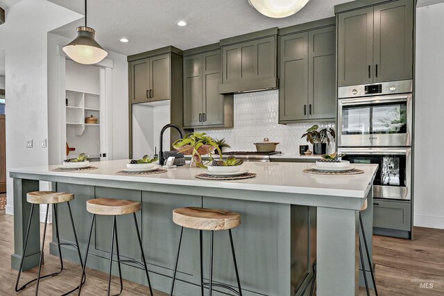 11844 N 21st Ave, Boise, ID 83714 - kitchen with stainless steel appliances, light wood-type flooring, light countertops, tasteful backsplash, and recessed lighting