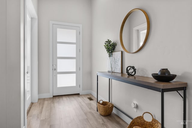 foyer entrance with light wood-type flooring