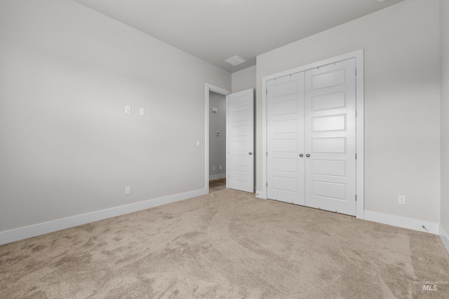 unfurnished bedroom featuring a closet and carpet floors