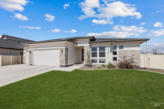 prairie-style home featuring a front lawn and a garage