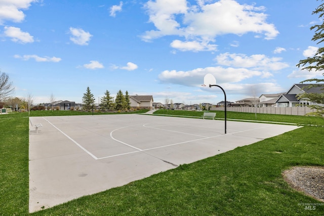 view of sport court with a lawn