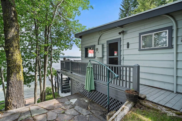 doorway to property with a deck with water view