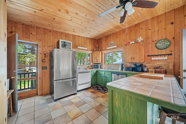 kitchen with wooden ceiling, tile counters, stainless steel appliances, and plenty of natural light