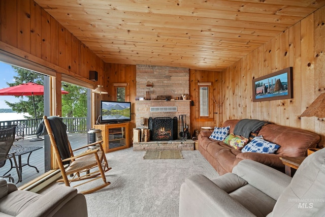 carpeted living room with a stone fireplace, wooden walls, wood ceiling, and lofted ceiling